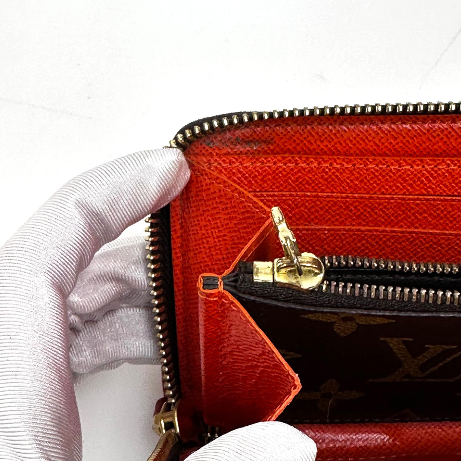 Louis Vuitton Portafoglio Zippé Clémence in Tela Monogram e arancio