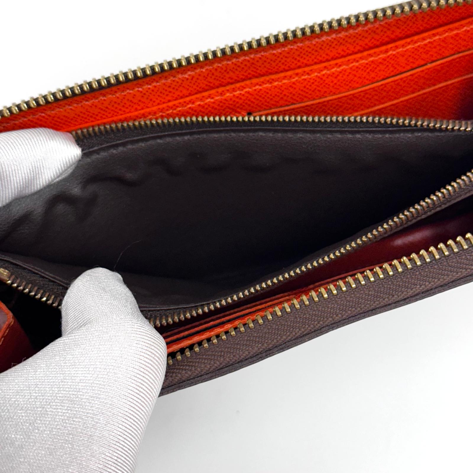 Louis Vuitton Portafoglio Zippé Clémence in Tela Monogram e arancio