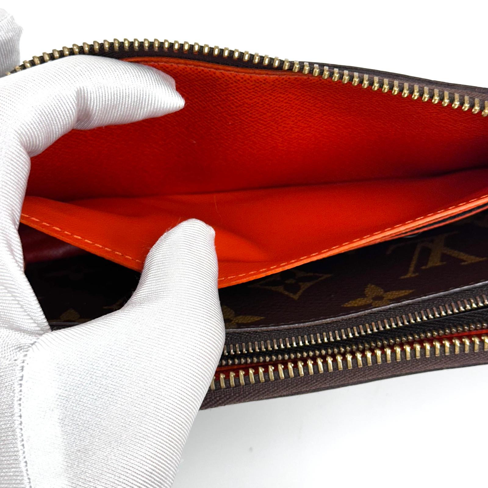 Louis Vuitton Portafoglio Zippé Clémence in Tela Monogram e arancio