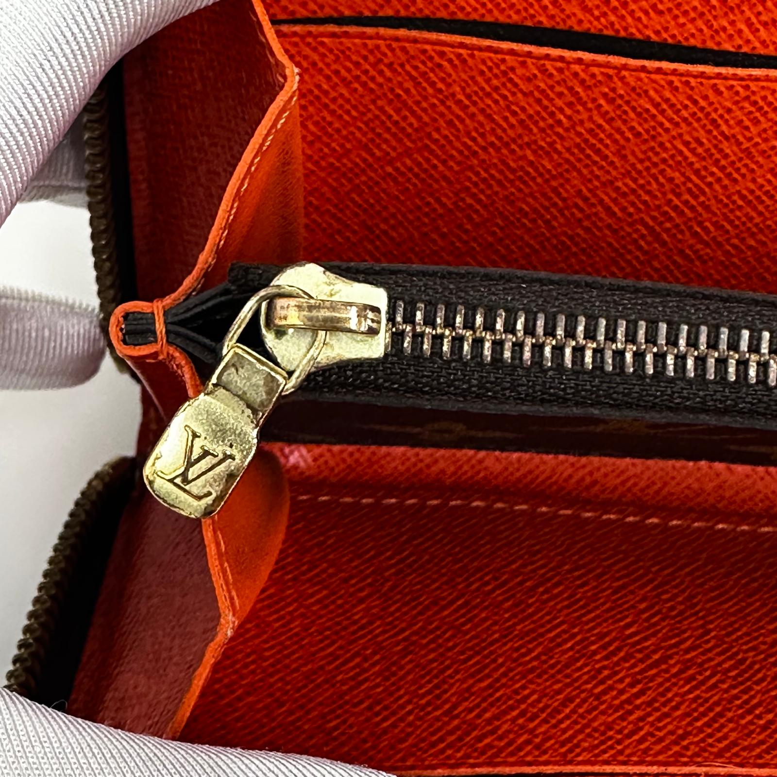 Louis Vuitton Portafoglio Zippé Clémence in Tela Monogram e arancio