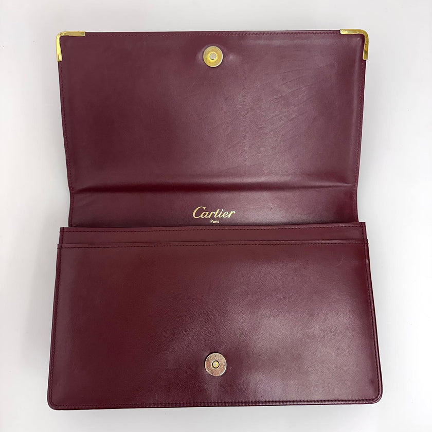 Cartier Borsa clutch in pelle bordeaux con logo centrale