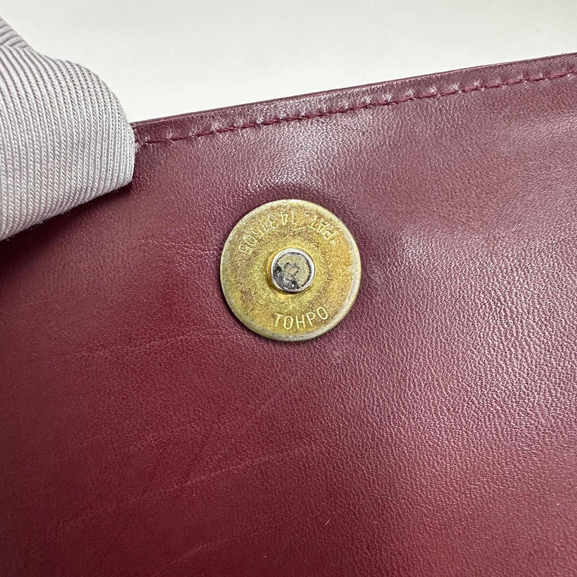 Cartier Borsa clutch in pelle bordeaux con logo centrale