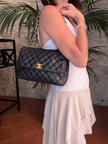Chanel Borsa Classic Flap 25 in Pelle Nera con Finiture in Oro 24k