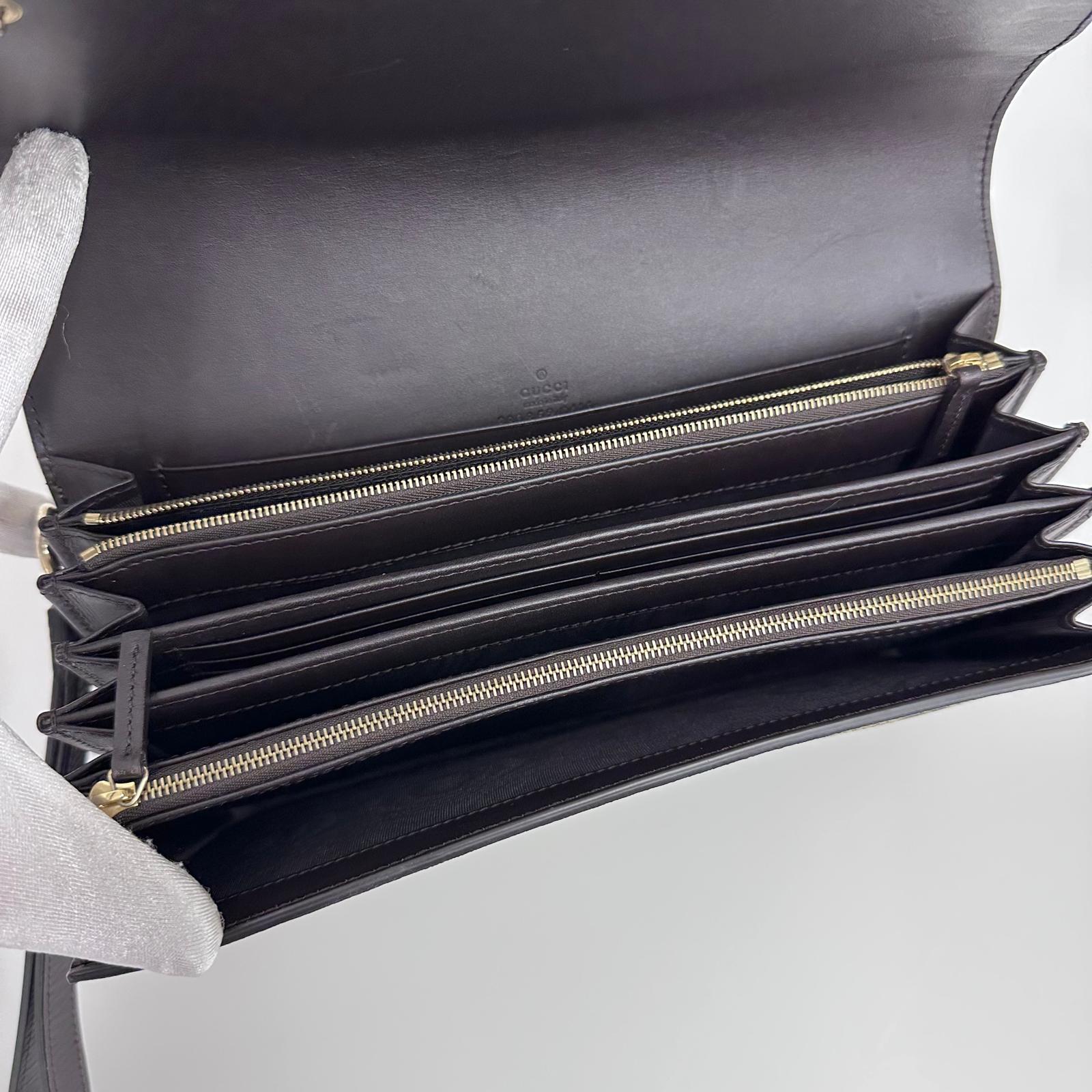 Gucci Clutch a mano GG Supreme con laccetto in pelle testa di moro