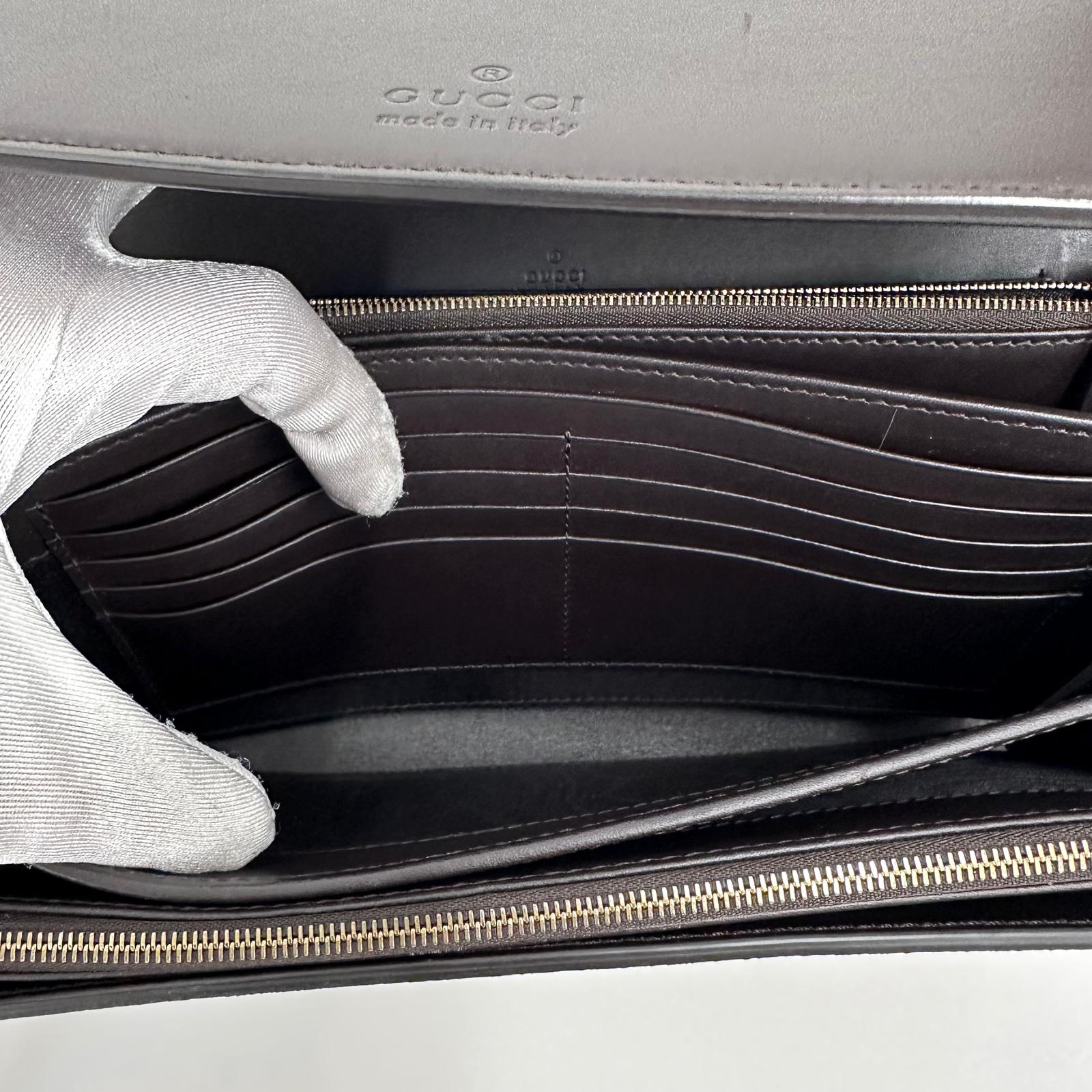 Gucci Clutch a mano GG Supreme con laccetto in pelle testa di moro