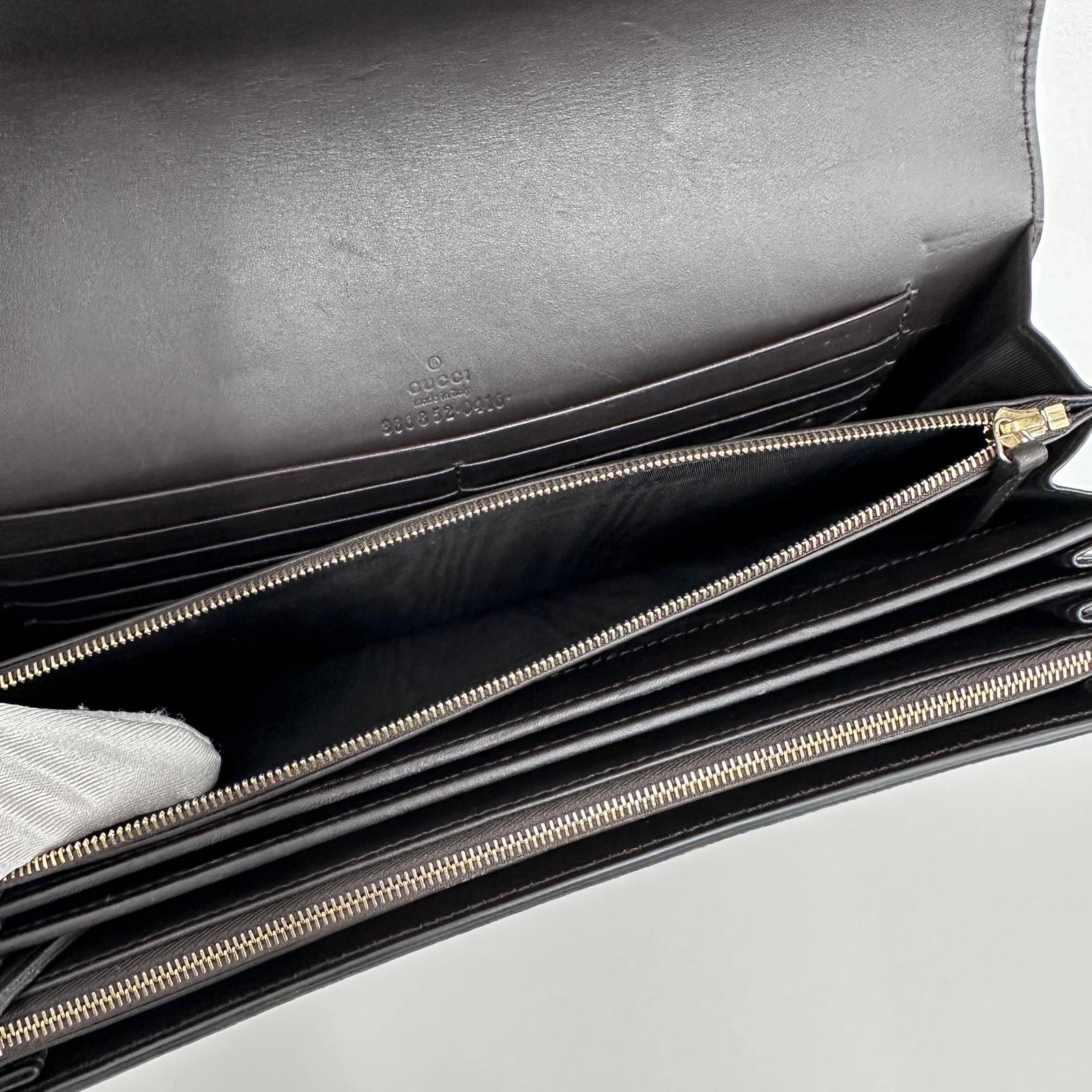 Gucci Clutch a mano GG Supreme con laccetto in pelle testa di moro