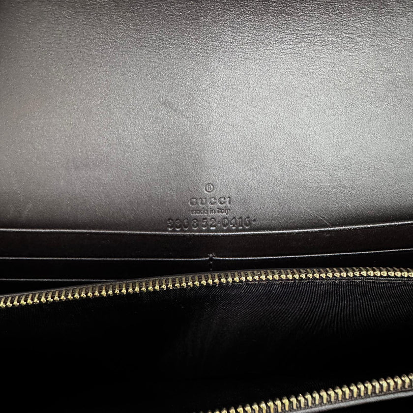 Gucci Clutch a mano GG Supreme con laccetto in pelle testa di moro