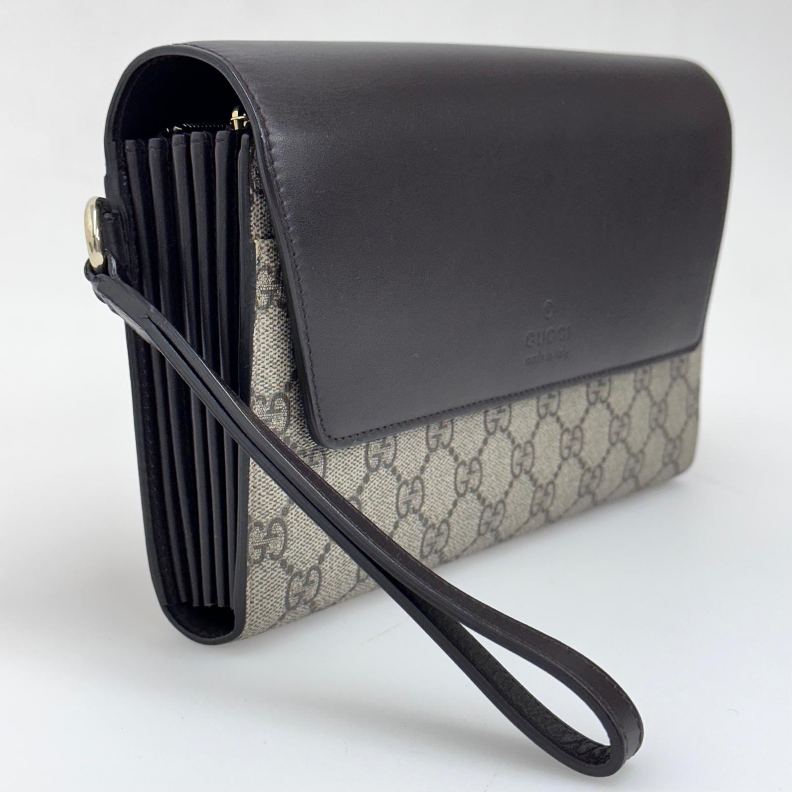 Gucci Clutch a mano GG Supreme con laccetto in pelle testa di moro