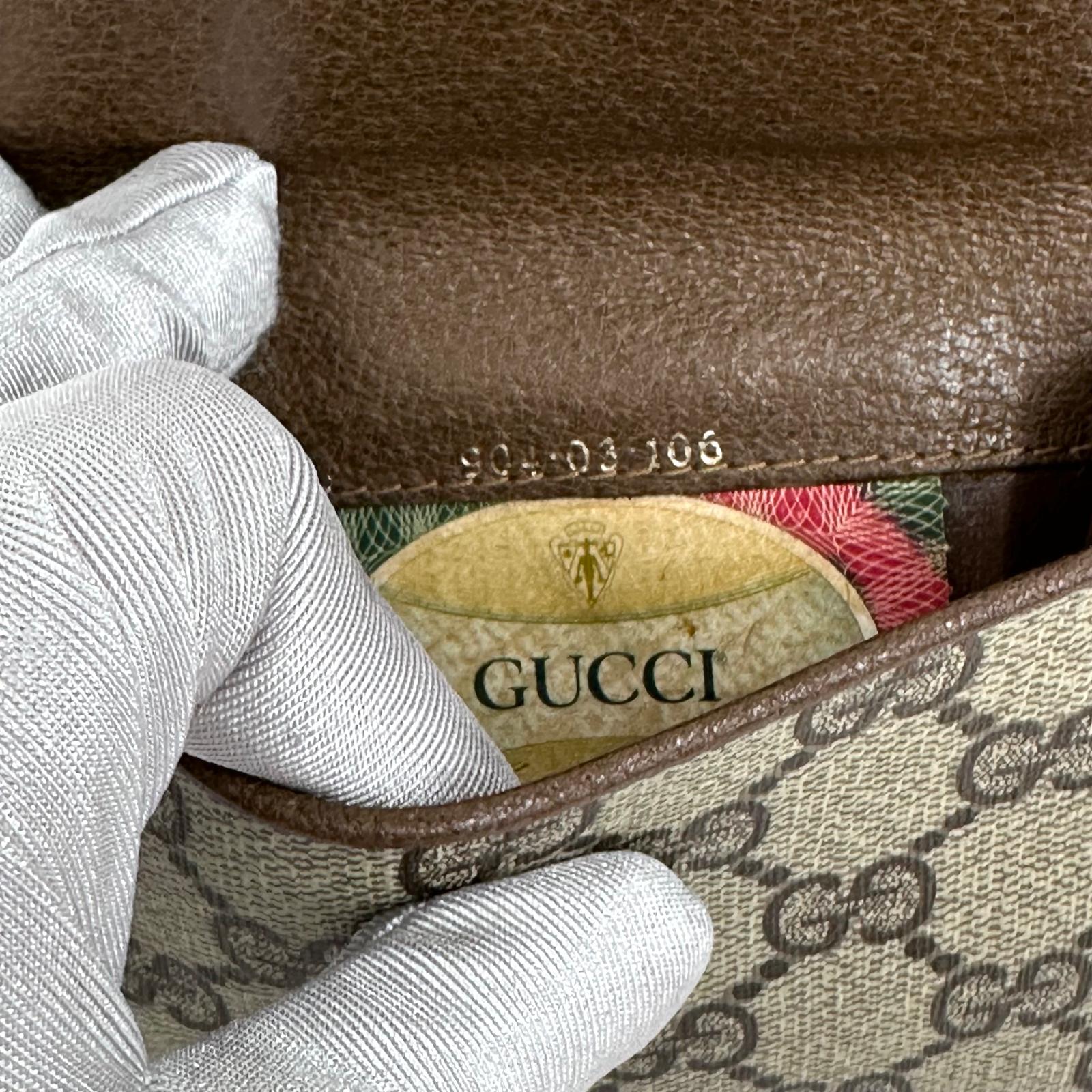 Gucci Portafoglio in tela GG Supreme e pelle marrone con chiusura Web
