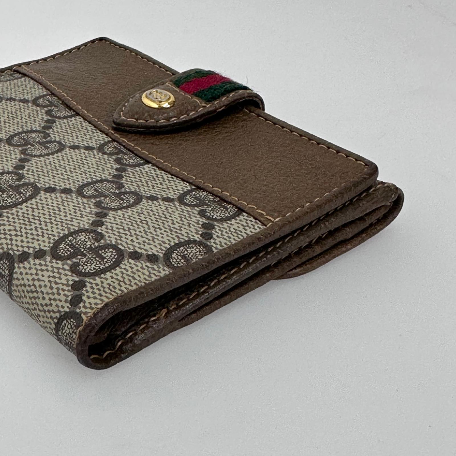 Gucci Portafoglio in tela GG Supreme e pelle marrone con chiusura Web