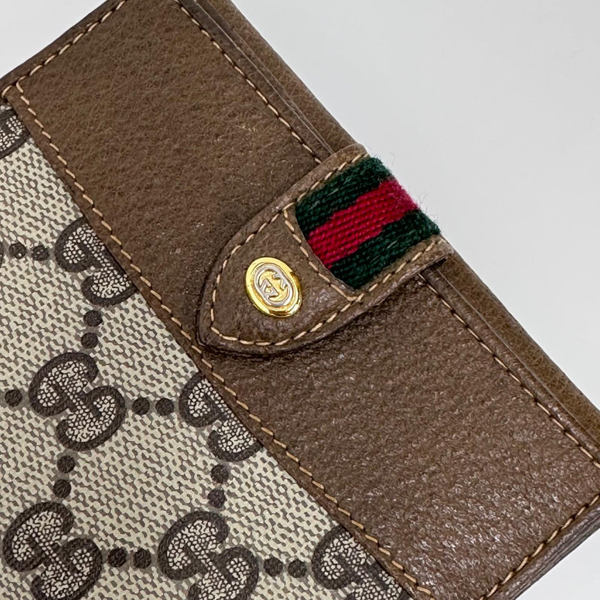 Gucci Portafoglio in tela GG Supreme e pelle marrone con chiusura Web