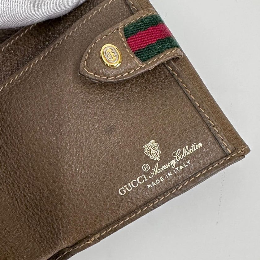 Gucci Portafoglio in tela GG Supreme e pelle marrone con chiusura Web