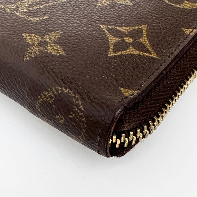 Louis Vuitton Portafoglio Zippé Clémence in Tela Monogram e arancio