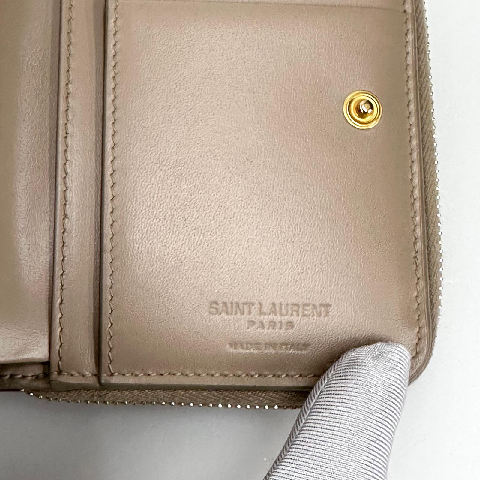 Saint Laurent Portafoglio compatto in pelle beige