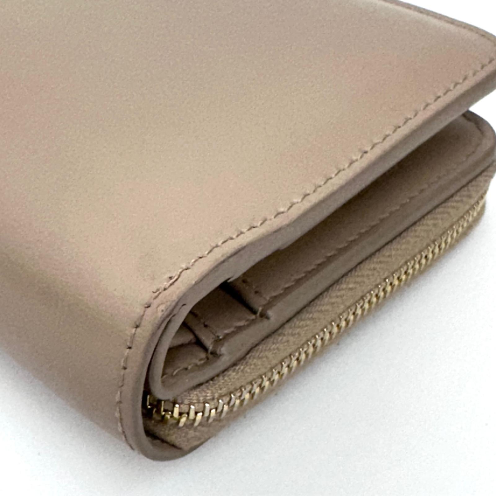 Saint Laurent Portafoglio compatto in pelle beige